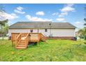 Back view of home with a spacious wood deck, complemented by a well-maintained backyard at 91 Buckingham Ct, Smithfield, NC 27577