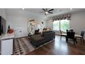 Inviting living room featuring a cozy sectional sofa, modern artwork, and ample natural light from the window at Lot 1 Northpointe Farms Trl, Efland, NC 27243
