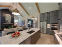 Spacious kitchen featuring an island, stainless steel appliances, gray cabinets, hardwood floors and an open floor plan at Lot 2 Northpointe Farms Trl, Efland, NC 27243