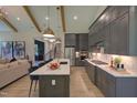 Modern kitchen featuring an island, gray cabinets, stainless steel appliances, hardwood floors, and an open floor plan at Lot 2 Northpointe Farms Trl, Efland, NC 27243