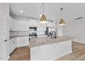 Modern kitchen featuring white cabinets, stainless appliances, and a granite island at 100 Ripple Way # 317, Clayton, NC 27520