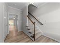 Bright entryway with wooden floors and staircase leading upstairs at 10133 Bessborough Dr, Raleigh, NC 27617