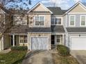 Inviting townhouse features an attached garage and a well-maintained lawn, offering both convenience and a pleasing aesthetic at 10133 Bessborough Dr, Raleigh, NC 27617