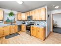 Modern kitchen with stainless steel appliances, ample light wood cabinetry, and mosaic tile backsplash at 104 Black Cloud Dr, Louisburg, NC 27549