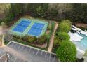 Aerial view of the community tennis courts and parking area, set near the pool at 11011 Southwalk Ln, Raleigh, NC 27614