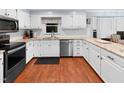 Updated kitchen features white cabinets, stainless steel appliances, and light countertops at 114 Oxpens Rd, Cary, NC 27513