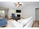 Cozy living room with fireplace, ceiling fan, and comfortable seating at 121 Viajar Way, Smithfield, NC 27577