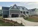 Beautiful new home features a spacious driveway leading to a three-car garage, complemented by landscaped front yard at 1221 Azalea Garden Cir, Raleigh, NC 27603