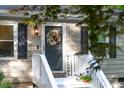 Inviting front door with 'Welcome' sign, a wreath, and freshly painted stairs at 1332 Stallings Rd, Chapel Hill, NC 27516
