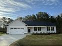 Inviting one-story home with a manicured lawn, two-car garage, and stylish exterior paint at 170 Eason Creek Way, Clayton, NC 27527