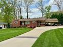 Charming single-story red brick home with well-manicured lawn and inviting curb appeal at 1802 Greenbriar Rd, Henderson, NC 27536