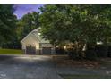 Charming two-story home featuring a two-car garage and a beautifully landscaped front yard at twilight at 181 Fawn Hill Ct, Garner, NC 27529
