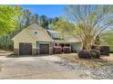 Charming two-story home featuring a well-manicured lawn, mature tree, and inviting curb appeal with a two car garage at 181 Fawn Hill Ct, Garner, NC 27529
