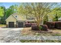 Charming two-story home featuring a well-manicured lawn, mature tree, and inviting curb appeal with a two car garage at 181 Fawn Hill Ct, Garner, NC 27529