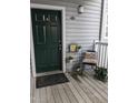 Charming front porch with potted plants, a black door, and a welcoming atmosphere at 1911 Wolftech Ln # 204, Raleigh, NC 27603