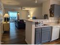 Open kitchen view into the living room, featuring modern appliances and hardwood floors at 1911 Wolftech Ln # 204, Raleigh, NC 27603