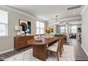 Open dining room with hardwood floors, modern decor, a large table with seating for six, and natural light at 192 Solheim Ln, Raleigh, NC 27603
