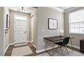 Inviting entryway with a white front door, side table, art, and natural light from a window at 192 Solheim Ln, Raleigh, NC 27603