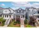 Charming two-story home features a welcoming front porch and well-maintained landscaping at 221 Douglas Falls Dr, Wendell, NC 27591