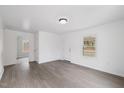 Bright and airy living room featuring wood-look floors, fresh paint, and ample natural light at 226 1St St, Henderson, NC 27536