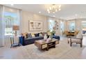 Bright living room showcasing stylish furnishings, artwork, and large windows with natural light at 2265 Kettle Falls Sta, Apex, NC 27502