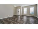 Bright living room with new, gray flooring and a white front door at 2321 Stony Bottom Dr, Raleigh, NC 27610
