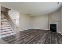 A spacious living room featuring a fireplace, staircase, and recently updated flooring at 2321 Stony Bottom Dr, Raleigh, NC 27610