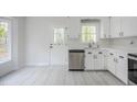 Kitchen showcasing stainless steel appliances, modern countertops, and a convenient door to the backyard at 2400 Hemlock Cir, Clayton, NC 27520