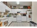 Functional kitchen featuring white cabinetry, appliances, and tile flooring at 2521 Friedland Pl # 201, Raleigh, NC 27617