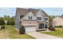 Beautiful two-story home showcasing gray siding, brick accents, and a spacious driveway at 265 Beckwith Ave, Clayton, NC 27527