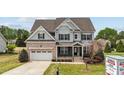 Charming two-story home featuring a brick and siding exterior, attached garage, and well-manicured landscaping at 265 Beckwith Ave, Clayton, NC 27527