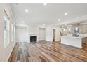Bright, spacious living room features wood floors and a fireplace, seamlessly connected to the kitchen at 272 Hiking Hill Ln, Garner, NC 27529