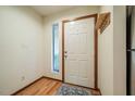 Bright foyer with white front door, wood floors and space for a small table at 308 Cedarwood Ln, Carrboro, NC 27510