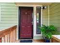 Inviting front door with a dark-colored exterior and cozy plants at 308 Cedarwood Ln, Carrboro, NC 27510