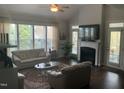 Inviting living room with a fireplace, lots of natural light, ceiling fan, and hardwood flooring at 338 Apalachia Lake Dr, Fuquay Varina, NC 27526