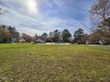 Community pool with large green space, trees and clear blue sky, perfect for community gatherings and relaxation at 3421 E E Jameson Rd, Raleigh, NC 27604