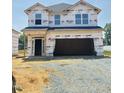 New construction home featuring a covered entrance and an attached two-car garage at 384 Hopewell Branch Ct, Smithfield, NC 27577