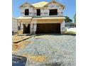 New construction home featuring the exterior framework and an attached two-car garage at 384 Hopewell Branch Ct, Smithfield, NC 27577