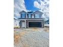 New two-story home featuring stone accents, an attached two-car garage, and a well-manicured lawn at 384 Hopewell Branch Ct, Smithfield, NC 27577