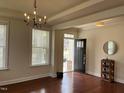 Bright entryway featuring hardwood floors, a modern chandelier, and natural light at 3908 Bostwyck Dr, Fuquay Varina, NC 27526