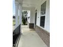 Inviting front porch with brick accents and classic columns at 3908 Bostwyck Dr, Fuquay Varina, NC 27526