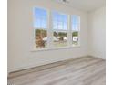 Bright bedroom with large windows offering a view of the neighborhood at 426 Adams Pointe Ct, Angier, NC 27501