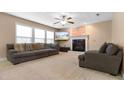 Spacious living room features a cozy fireplace, large windows, and comfortable seating, perfect for relaxation at 43 Summerseat Way, Bunnlevel, NC 28323