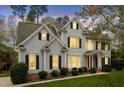 Elegant two-story home showcases traditional black shutters, a red front door, and manicured landscaping at 4313 Branchwood Dr, Durham, NC 27705