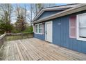 Spacious wooden deck on a blue sided home with pink shutters at 4502 Mill Creek Rd, Cedar Grove, NC 27231