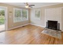 Bright living room featuring hardwood floors, fireplace, and ample natural light at 4502 Mill Creek Rd, Cedar Grove, NC 27231