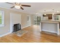 Open-concept living room with a fireplace and seamless access to the kitchen at 4502 Mill Creek Rd, Cedar Grove, NC 27231