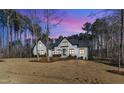 Elegant two-story home with lush landscaping, a well-manicured lawn, and inviting curb appeal at 472 Stonecrest Way, Pittsboro, NC 27312