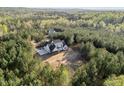 Aerial view of home nestled within a lush green forest, offering privacy and serenity at 494 Terry Rd, Hillsborough, NC 27278