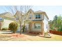 Charming two-story home featuring a welcoming front porch and a neatly landscaped yard at 504 Prince Dr, Holly Springs, NC 27540